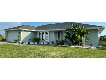 Newly built home with a landscaped lawn and attached garage at 254 Mark Twain Ln, Rotonda West, FL 33947