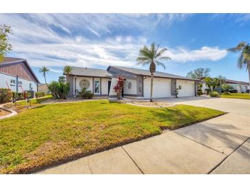 Single-story home with a two-car garage and lush lawn at 545 Foxwood Blvd # 23, Englewood, FL 34223