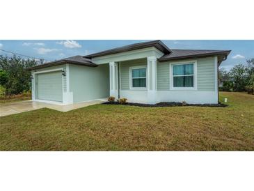 One-story home with light green siding, attached garage, and a well-maintained lawn at 7186 Rosemont Dr, Englewood, FL 34224