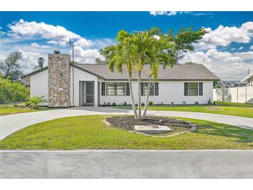 Newly renovated home with a modern exterior and landscaped yard at 7329 Mamouth St, Englewood, FL 34224