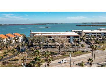 Aerial view of waterfront community with lush landscaping and parking at 1501 Beach Rd # 209, Englewood, FL 34223