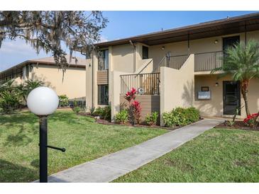 Inviting two-story condo with beautiful landscaping, walkways, and a well-maintained facade at 4072 Oakview Dr # C8, Punta Gorda, FL 33980
