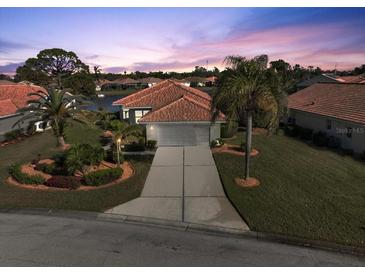 Attractive single-story home with a tile roof and landscaped yard at 6730 Greenview Ln, Englewood, FL 34224