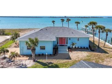 Waterfront home featuring a new roof, lush landscaping, and a private dock at 1906 Mississippi Ave, Englewood, FL 34224