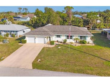 Charming single-story home featuring a two-car garage and well-manicured lawn at 3204 Depew Ave, Port Charlotte, FL 33952