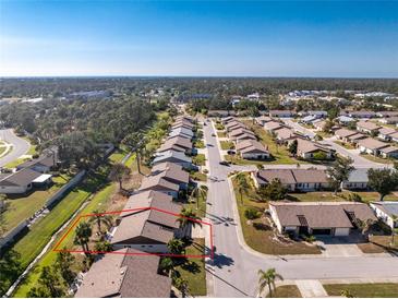 An aerial view of a residential neighborhood showcasing single Gathering homes with well-maintained landscaping at 525 Foxwood Blvd, Englewood, FL 34223