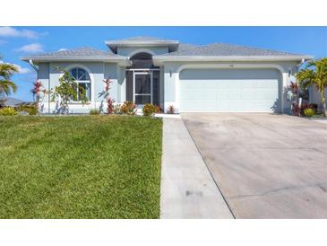 Charming single-story home with well-manicured lawn and two-car garage at 170 Long Meadow Ln, Rotonda West, FL 33947