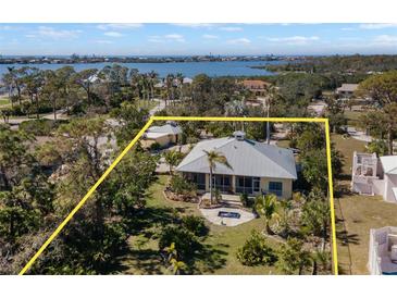 Beautiful waterfront home featuring mature landscaping and large lot at 1320 Bayshore Dr, Englewood, FL 34223