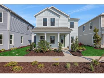 Charming two-story home with a welcoming front porch and landscaped yard at 9039 Duany Ln, Lakewood Ranch, FL 34240