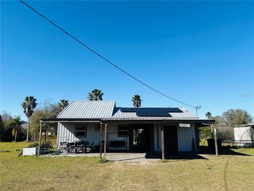 Single story home with metal roof and solar panels, spacious backyard at 7301 Anacapa Ln, Plant City, FL 33565