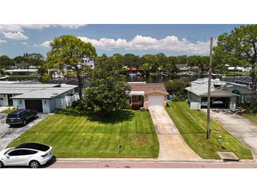 Aerial view of a single-story home with a large backyard and waterfront access at 237 Tallahassee Ne Dr, St Petersburg, FL 33702