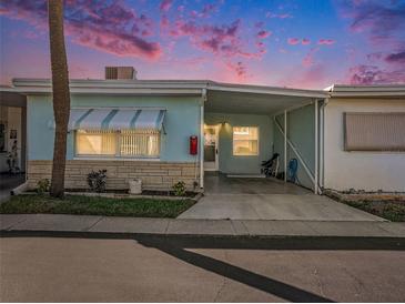 Light blue exterior with carport and palm tree at 250 Rosery Nw Rd # 260, Largo, FL 33770