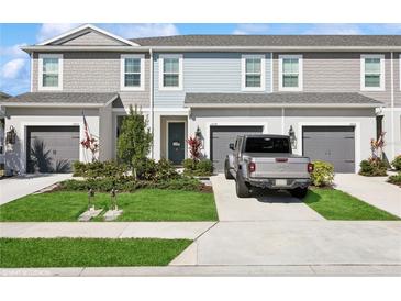 Charming townhome featuring a one-car garage, well-maintained lawn, and welcoming curb appeal at 11658 Bluestone Ct, Parrish, FL 34219