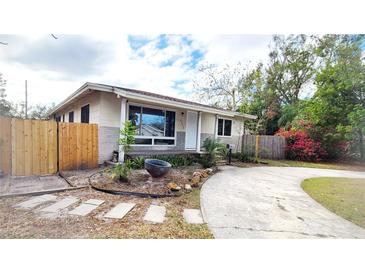 Charming single-story home featuring a brick accent, quaint landscaping, and a paved driveway at 2954 37Th N Ave, St Petersburg, FL 33713