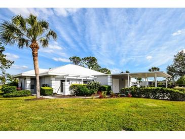 Single-story home with carport and lush landscaping at 266 Cerromar S Way # 55, Venice, FL 34293