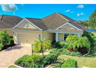 One-story home with tile roof, landscaping, and two-car garage at 11613 Marathon Cir, Venice, FL 34293