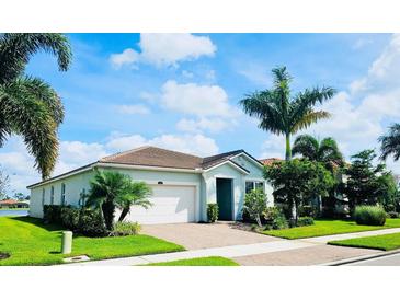 Single-story home with a two-car garage and landscaping at 11684 Renaissance Blvd, Venice, FL 34293