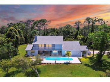 Aerial view of single-Gathering home with pool and private lake at 5885 Denison Dr, Venice, FL 34293