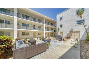 Relaxing courtyard with seating area and grill at 708 Tamiami S Trl # 308, Venice, FL 34285