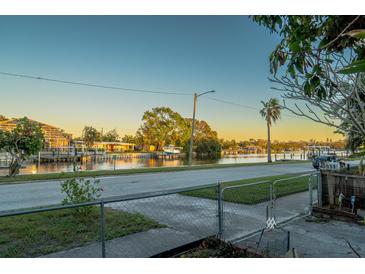 Scenic waterfront view of a peaceful canal with boats and lush greenery at 3911 Sunrise S Dr, St Petersburg, FL 33705