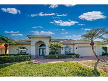 Beautiful one-story home with a lush lawn and palm trees at 746 Fringed Orchid Trl, Venice, FL 34293