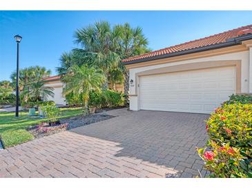 White double garage door with paver driveway at 9847 Haze Dr, Venice, FL 34292