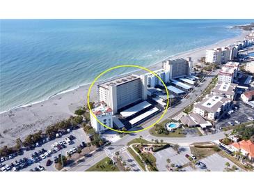 Aerial view of beachfront condo building with parking and pool at 255 The Esplanade N # 603, Venice, FL 34285