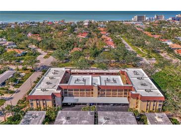 Aerial view showing condo building, parking, and neighborhood at 101 Park S Blvd # 111, Venice, FL 34285