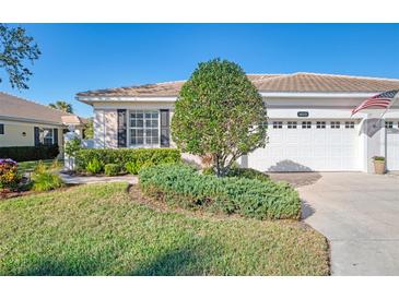 Well-maintained house with a two-car garage and manicured lawn at 1613 Monarch Dr # 1613, Venice, FL 34293