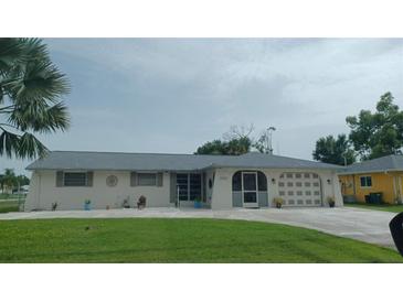 Ranch style home with gray roof and landscaping at 20263 Hamilton Ave, Port Charlotte, FL 33952