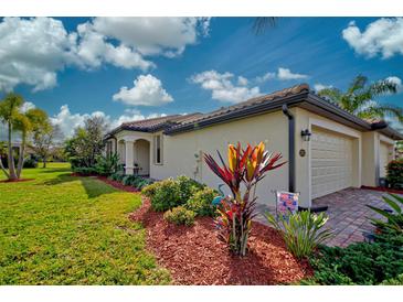 Beautiful home with landscaped yard and two-car garage at 20272 Tesoro Dr, Venice, FL 34293