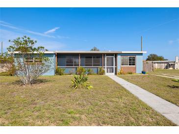 Ranch style home with screened porch and landscaped lawn at 370 Waltham St, Port Charlotte, FL 33952