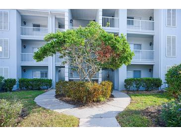 Attractive building exterior with landscaping and walkway at 404 Cerromar N Cir # 116, Venice, FL 34293