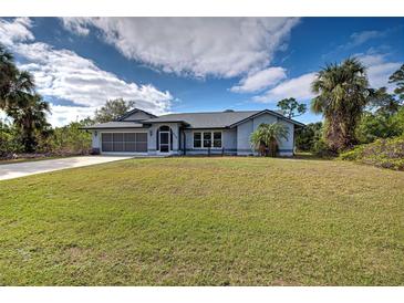 Single-story home with gray roof, screened porch, and large yard at 419 Ramblewood St, Port Charlotte, FL 33953
