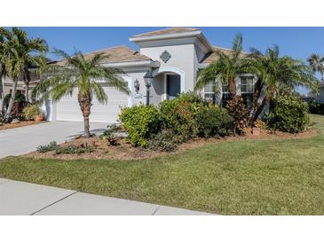 Single-story home with two-car garage and landscaped yard at 12198 Wakulla Pl, Venice, FL 34293
