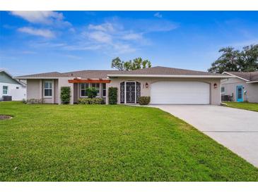 Single-story home with a landscaped lawn and attached garage at 1236 Pinebrook Way, Venice, FL 34285