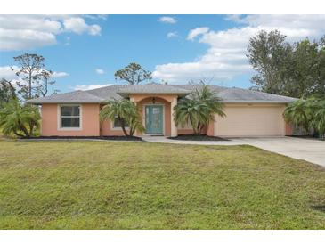 Single-story house with a teal door and palm trees at 13421 Gershwin Ln, Port Charlotte, FL 33981