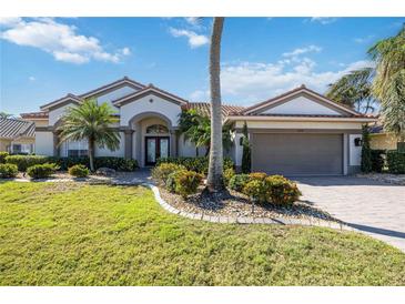 Beautiful one-story home with a tile roof, landscaping, and a two-car garage at 1348 Reserve Dr, Venice, FL 34285