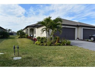 Single-story home with attached garage and landscaped front yard at 2009 Mackerel St, Port Charlotte, FL 33953