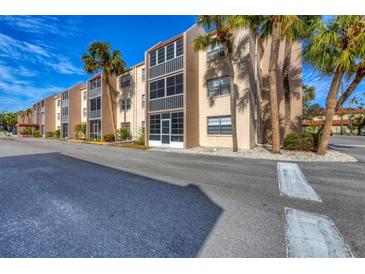 Two-story condo building with ample parking and lush landscaping at 519 Albee Farm Rd # 115, Venice, FL 34285
