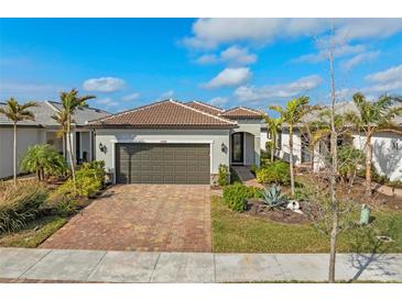 Single-story home with a two-car garage and landscaped front yard at 13756 Vadini St, Venice, FL 34293