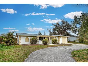 Single-story home with attached garage and landscaped yard at 151 Morningside Rd, Venice, FL 34293