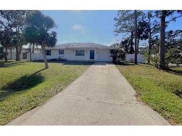 Cute one-story home with a long driveway and palm trees at 3110 Siesta Dr, Venice, FL 34293