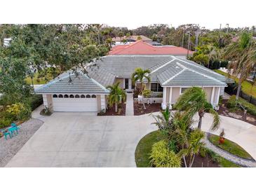 Attractive single-story home with a large driveway and landscaped yard at 315 Park N Blvd, Venice, FL 34285