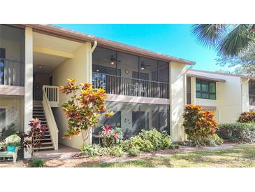 Exterior view of condo showing building, landscaping, and a stairway at 654 Bird Bay E Dr # 206, Venice, FL 34285