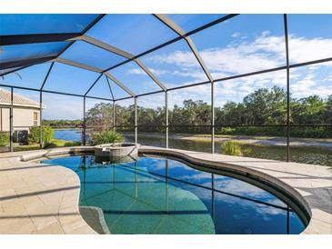 Relaxing screened-in pool and spa overlooking a serene waterway at 1206 Tuscany Blvd, Venice, FL 34292