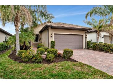 Single-story home with a two-car garage and landscaped front yard at 13836 Alafaya St, Venice, FL 34293