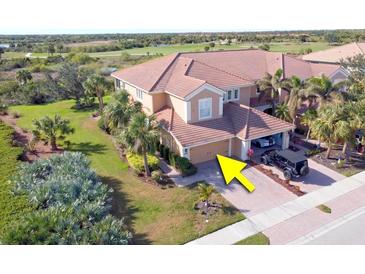 Aerial view of two-story townhome with two-car garage and golf course views at 23619 Awabuki Dr, Venice, FL 34293