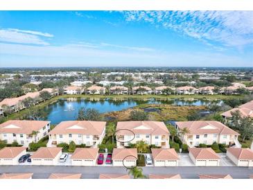 Aerial view of condo community with lake and lush landscaping at 4206 Vicenza Dr # C24, Venice, FL 34293