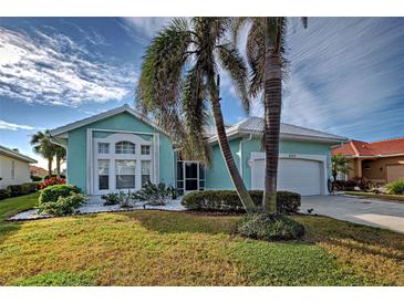 Single-story house with a two-car garage and landscaping at 660 Silk Oak Dr, Venice, FL 34293